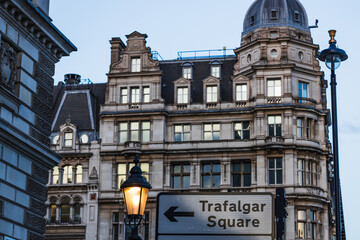London Trafalgar Square Direction Sign Against a Backdrop of Timeless Architecture