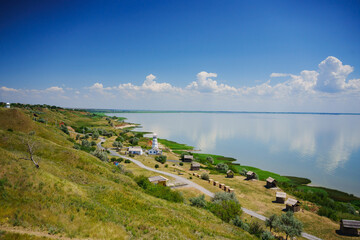 seashore. A beautiful blue sky with cumulus clouds over the sea surface. 