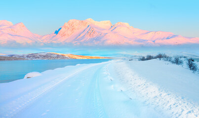 Beautiful winter landscape with snow and ice covered road - Tromso, Norway - Arctic landscape