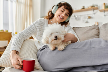 Joyful moments with a fluffy companion on a cozy couch in a sunny room