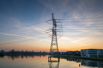 Fototapeta premium Electricity pylon over water after sunset