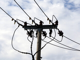 electric cable on concrete pole with blue sky background