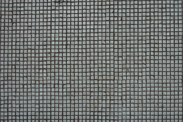 Texture of small white rectangular mosaic tiles
