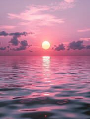 Tranquil Pink Sunset Reflecting Over Calm Sea With Gentle Clouds in the Sky