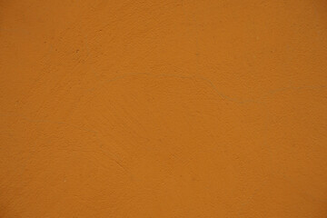 Close view of bright orange painted wall