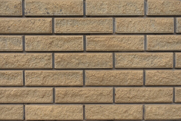 Background - sand brown split face brick veneer wall with stretcher bond
