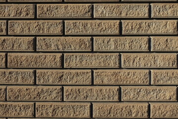 sand brown split face brick veneer wall with stretcher bond texture