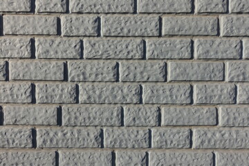 Close shot of Light grey painted brick veneer wall