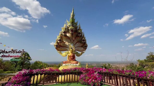 The statue of Lord Buddha is enshrined under the head of the Naga amazing and beautiful Naga statues in Tham Pha Daen Temple, Sakon Nakhon Thailand.