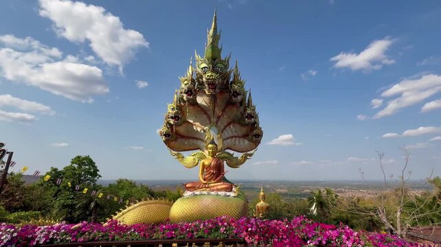 The statue of Lord Buddha is enshrined under the head of the Naga amazing and beautiful Naga statues in Tham Pha Daen Temple, Sakon Nakhon Thailand.