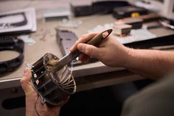 A Close Up and Detailed Examination of a Turbine Fan Component Held in Hand for Review