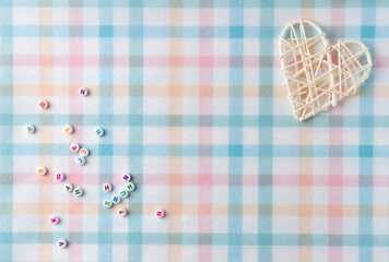 Beads with letters. Flat lay, top view. Copy space