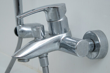 Close up of a water tap of a bathtub with limescale staines