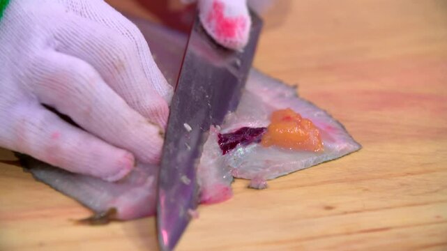 Filleting flatfish on a wooden cutting board