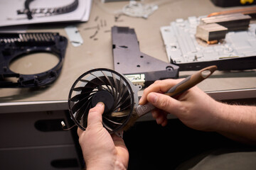 A Close Up and Detailed Examination of a Turbine Fan Component Held in Hand for Review