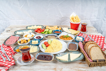 Breakfast table. Traditional Turkish breakfast with various appetizers, snacks, desserts, pastry, meat, hot and cold dishes, and tea. Turkish name is 'Serpme Kahvaltı'