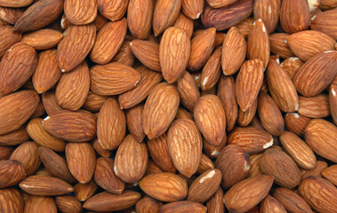 Pile of almonds ( texture, background ). Top view, flat lay