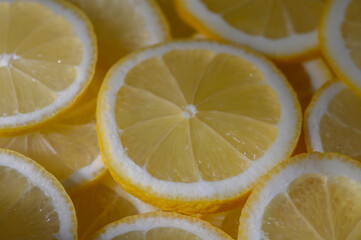 Freshly sliced lemons glisten under soft sunlight, creating a vibrant and refreshing display