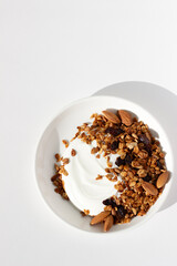 Breakfast Food. Greek Yoghurt with Homemade Granola with Walnuts, Sunflower Seeds, Raisins, and Almonds.