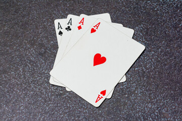 Deck of playing cards, with the top card showing the Ace of heart. The cards are stacked on top of each other