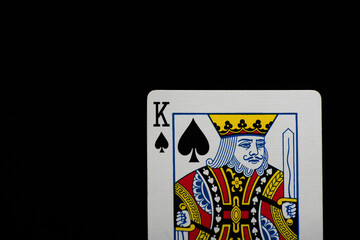 King playing card featuring a crowned figure holding a sword. The detailed design and bold colors symbolize power, strategy, and classic card game aesthetics.