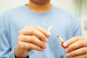Quit smoking, Asian man breaking destroy cigarette in hand.