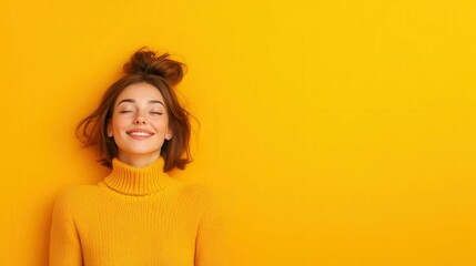 Joyful woman in bright yellow sweater embracing happiness and serenity