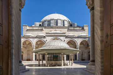 A photo of Yavuz Sultan Selim Mosque in Istanbul, taken from the entrance. The courtyard, domes,...