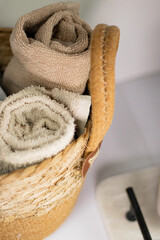 Soft towels neatly arranged in a straw basket in the bathroom, creating a cozy and inviting atmosphere.
