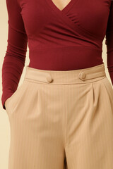 Series of studio photos of young female model wearing simple beautiful outfit, red v neck shirt and...