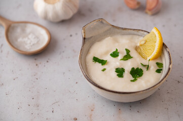 Lebanese Garlic sauce Toum or Salsat toum contains garlic, salt, olive oil and lemon juice....