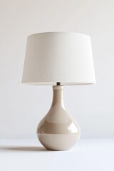 Beige ceramic table lamp, white shade, minimalist room