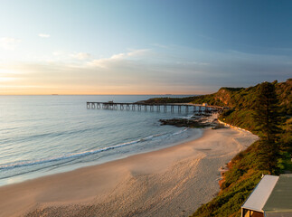 Golden hour sunrise over Historic Wallarah Jetty .Catherine Hill Bay. Central Coast of NSW. Australia.