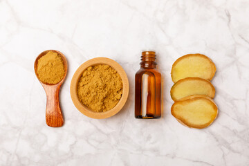 Ginger essential oil on texture background. Fresh ginger slices. Essence, serum, oil. Alternative medicine. Phytotherapy. Health and beauty concept. Place for text. Copy space.