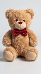 Obraz premium Stuffed bear with red bow tie on white backdrop, a possible gift or toy