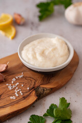 Lebanese Garlic sauce Toum or Salsat toum contains garlic, salt, olive oil and lemon juice on...