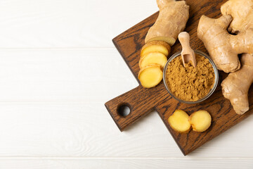 Fresh ginger on wooden background. Dry ginger. Sliced ​​ginger with honey and lemon. Ginger...
