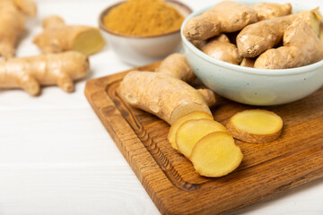 Fresh ginger on wooden background. Dry ginger. Sliced ​​ginger with honey and lemon. Ginger root. Traditional alternative medicine, healing tea for immunity. Seasoning and spices concept. Copy space.