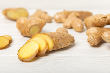 Fresh ginger on wooden background. Dry ginger. Sliced ​​ginger with honey and lemon. Ginger...