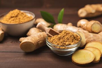 Fresh ginger on wooden background. Dry ginger. Sliced ​​ginger with honey and lemon. Ginger...