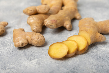 Fresh ginger on wooden background. Dry ginger. Sliced ​​ginger with honey and lemon. Ginger root. Traditional alternative medicine, healing tea for immunity. Seasoning and spices concept. Copy space.