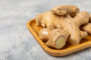 Fresh ginger on wooden background. Dry ginger. Sliced ​​ginger with honey and lemon. Ginger root. Traditional alternative medicine, healing tea for immunity. Seasoning and spices concept. Copy space.