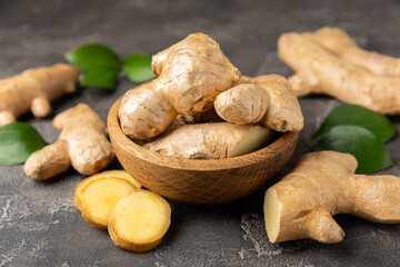 Fresh ginger on wooden background. Dry ginger. Sliced ​​ginger with honey and lemon. Ginger...