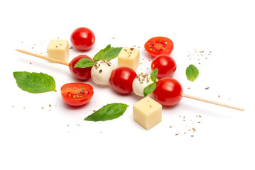 Caprese skewer with cherry tomatoes and basil leaves on a white background