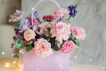Beautiful pink flowers composition in the box close-up view. Festive decoration and background