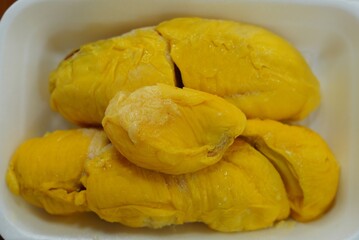 Fresh yllow durian fruit cut open in Singapore
