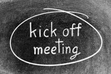 Fototapeta premium White chalk hand writing in word kick off meeting and circle shape on blackboard background