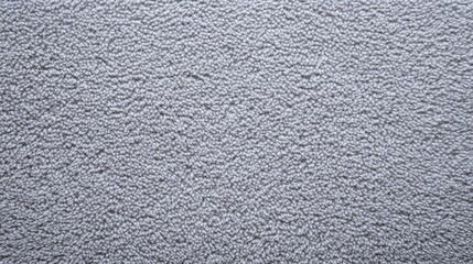 Fototapeta premium A textured gray surface with a slightly rough appearance, resembling a wall or fabric.
