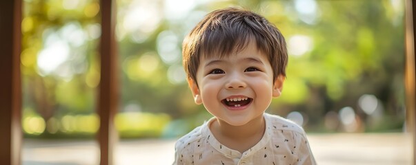 A joyful young boy smiles brightly showcasing missing front teeth