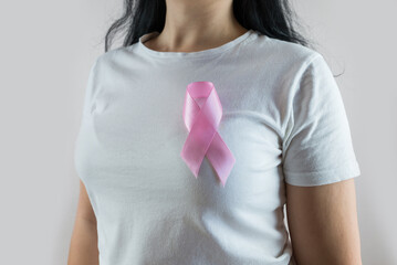 Woman holding pink ribbon breast cancer awareness. Women's medical examination of consciousness.
